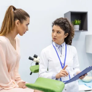 Gynecologist discussing medical information with patient in examination room